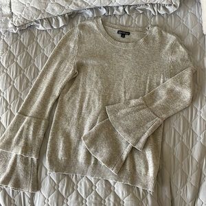 J. Crew mercantile grey sweater with ruffled sleeve details.